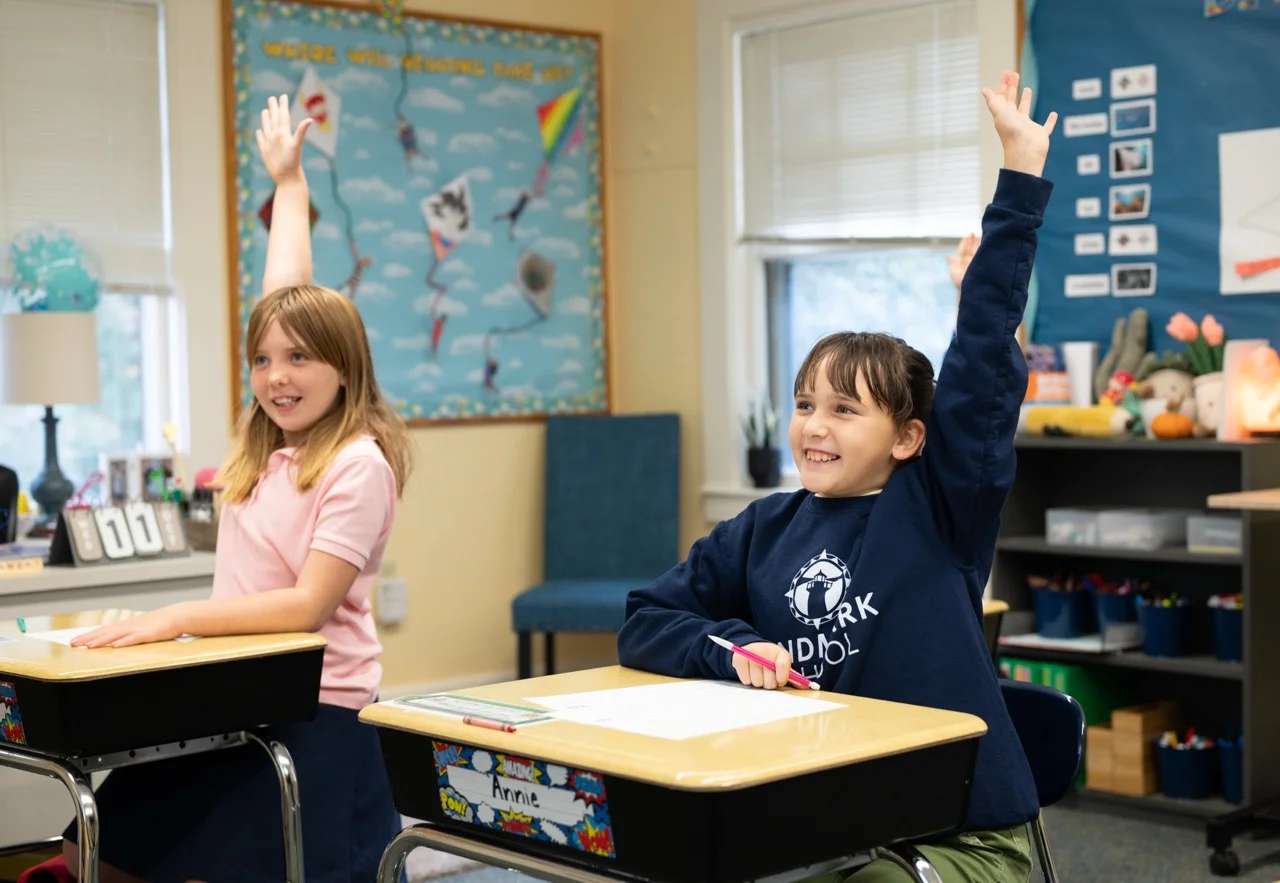 young students raising hand eagerly